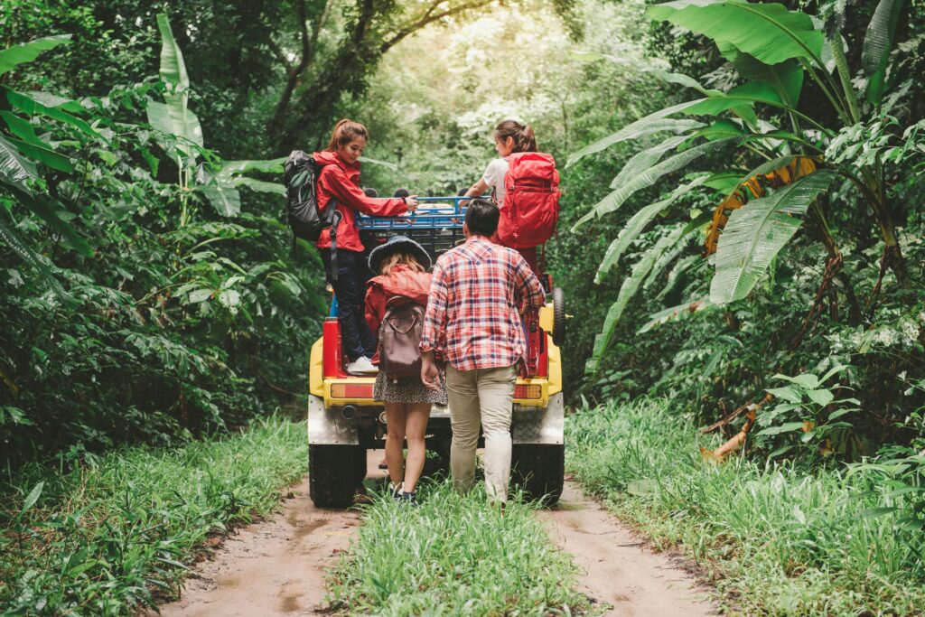pexels-photo-887828-887828 Friends hiking in a tropical forest, riding a jeep with backpacks, enjoying the adventure.